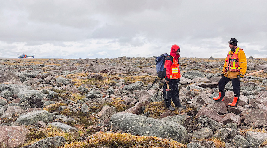 two miners exploring in a field of rocks