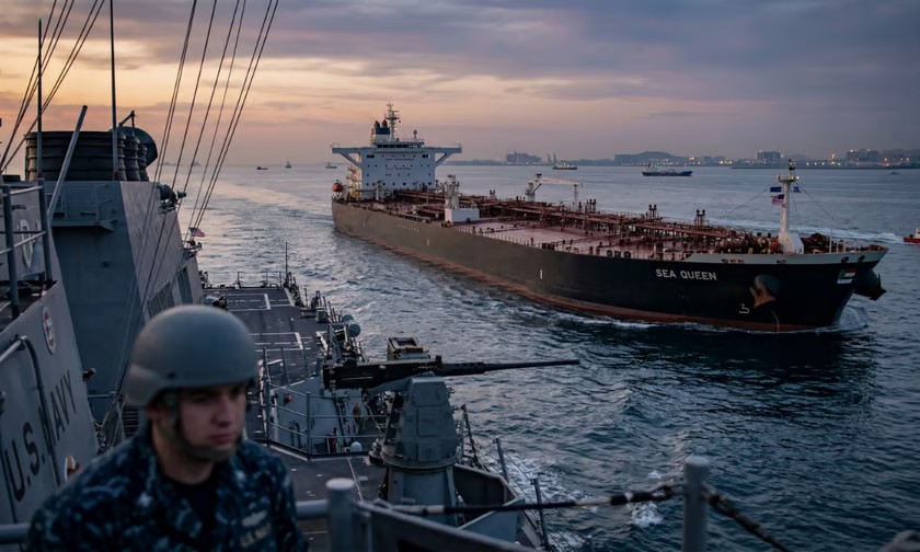 A warship escorting an oil tanker