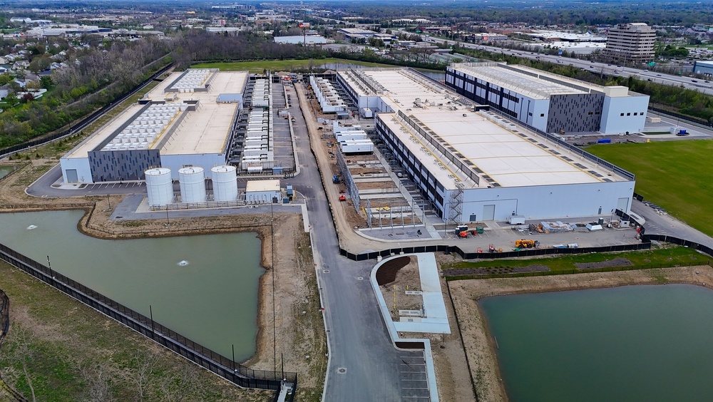 Arial view of a large data center with pools of water in the foreground