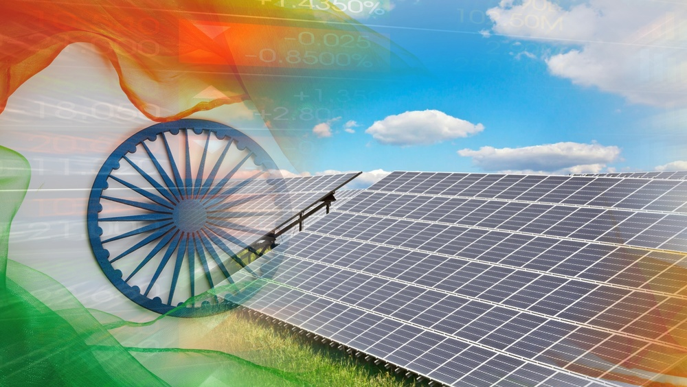 The flag of India overlaid on a scene of solar panels under blue sky